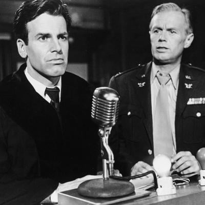 Maximilian Schell and Richard Widmark stand in a courtroom in a still from the film 'Judgment At Nuremberg'.