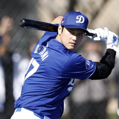Shohei Ohtani #17 of the Los Angeles Dodgers swings the bat during workouts.