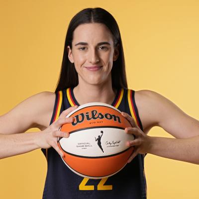 Caitlin Clark of the Indiana Fever poses for a photo while holding a basketball.