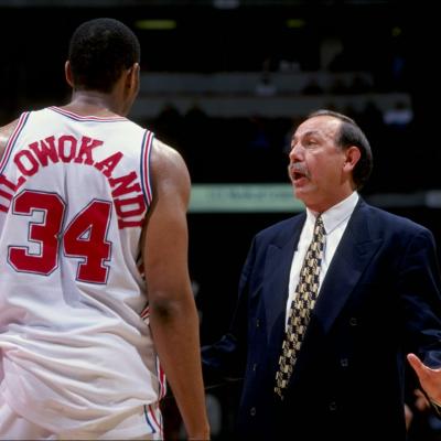 Los Angeles Clippers head coach Chris Ford talks to Michael Olowokandi during a game.