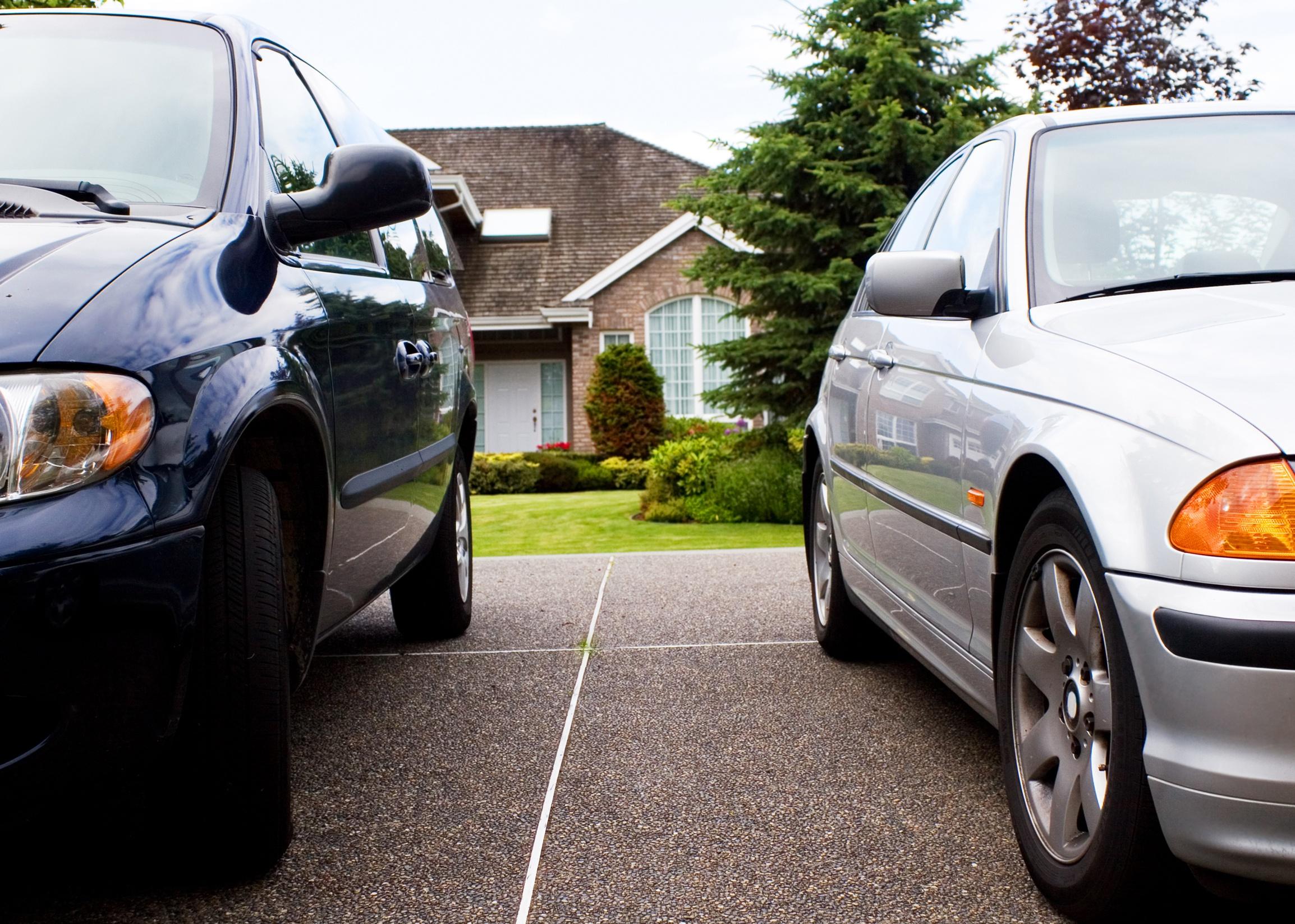 Two cars parked in a driveway.
