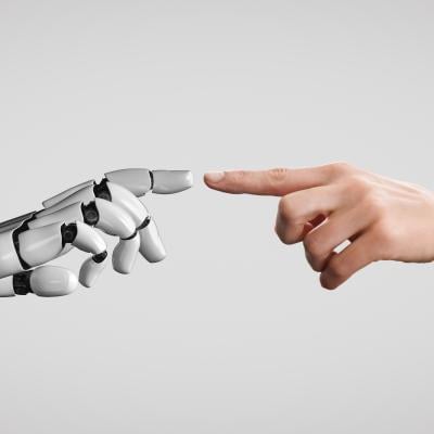 Human and robot fingers touching. 