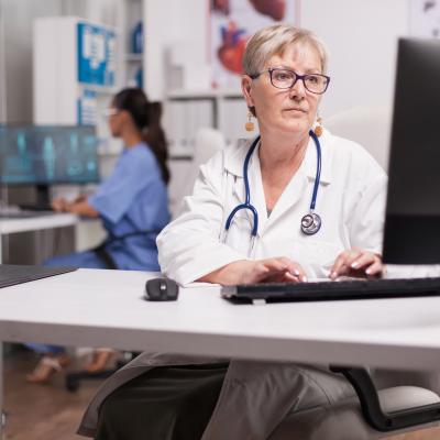 Doctor using computer in clinic.