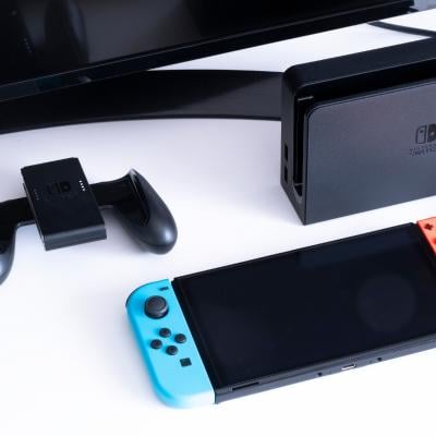 Nintendo Switch video game console next to the TV in a home living room.