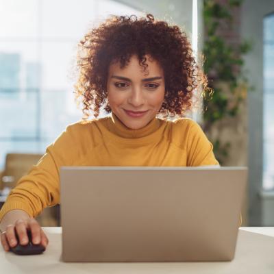 Young woman with curly hair on computer.