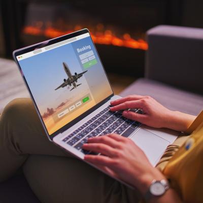 A woman booking plane tickets using computer.