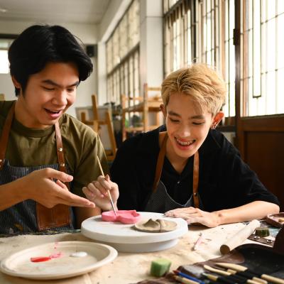 Two students working on ceramics.