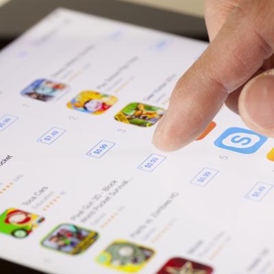 Close-up of a hand scrolling on the App Store on an iPad.