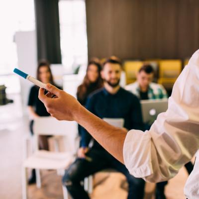 Back view of a lecture and training session in an office.