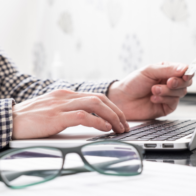 A person entering personal information into a computer.