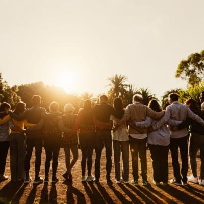 A large family locking arms.