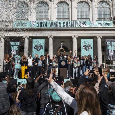 Members of the New York Liberty team celebrate their championship at a ticker tape parade.