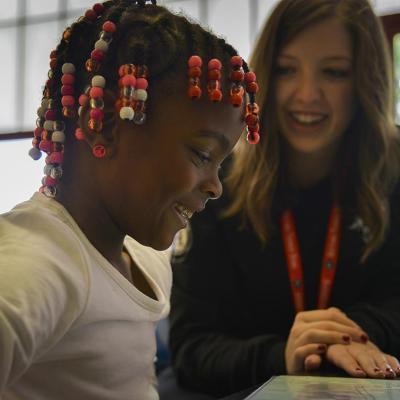 Americorps reading tutor Kelly Meany, L, gives one-on-one reading instructions to 7-year-old 2nd grader Madissen Moody at C.W. Harris Elementary School in D.C where Corps members play a huge role in DC public schools, teaching kids to read and acting as role models, on Friday, September 19, 2014