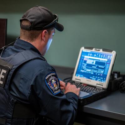 A police officer uses his computer in Georgetown, Texas, in 2023.