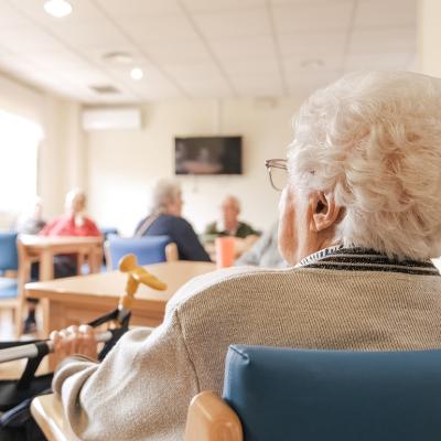 Elderly woman in a nursing home activity area.
