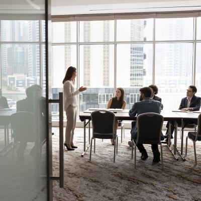 A business team engaged in a discussion in a meeting room.