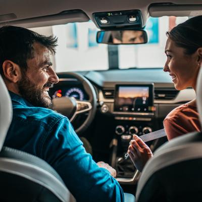 Couple inside a brand new car.
