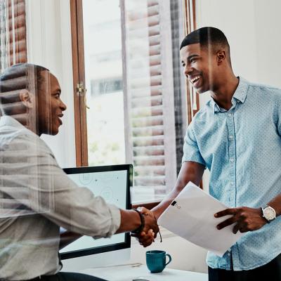 Two businessmen shaking hands after a meeting.