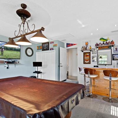 A pool table covered in leather in a game room.