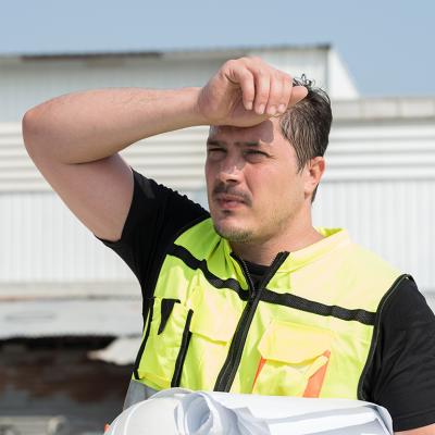 Foreman construction worker wiping sweat while at work.