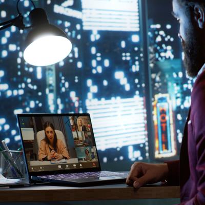 An employee working from home in a videocall session with the CEO and other employees.