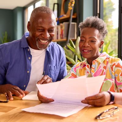 Senior couple at home reviewing finances.