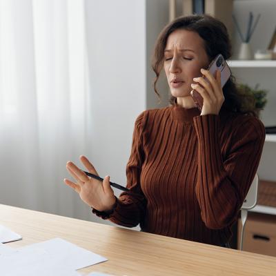 Woman worryingly talking on the phone.