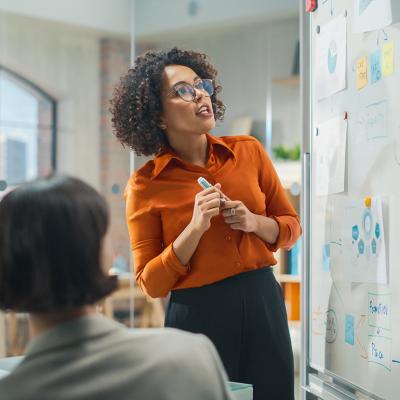 Businesswoman leading a presentation to her creative team.