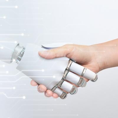 Human hand shaking robot hand, symbolizing human-robot collaboration and technology.