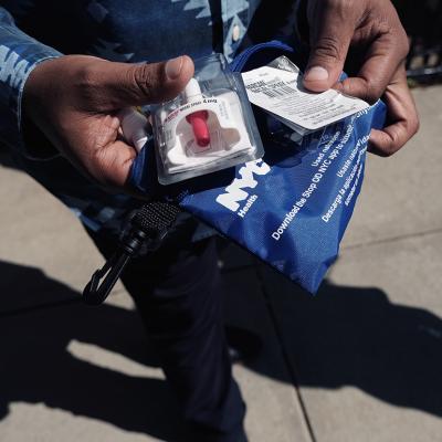 A Services for the UnderServed (S:US) worker holds a naloxone overdose kit.