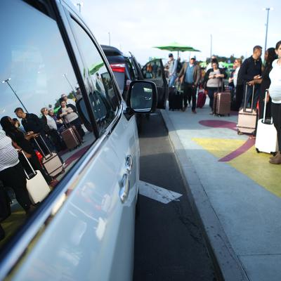 Arriving passengers wait to board Uber vehicles at the new 'LAX-it' ride-hail passenger pickup lot at Los Angeles International Airport (LAX) in California.