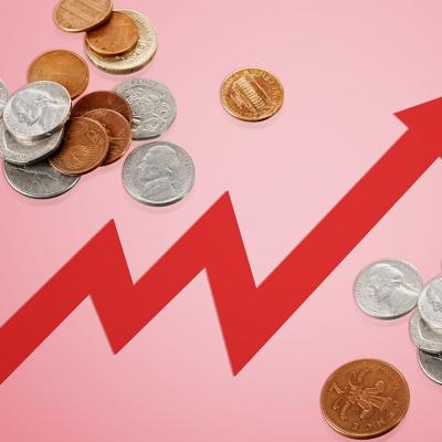 Rising arrow to depict rising costs against a background of coins.