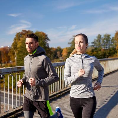 A couple running outdoors in the morning.