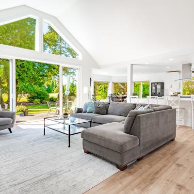 A large open living room with multiple expansive windows.
