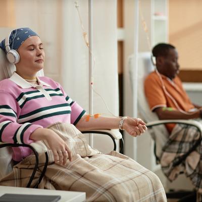 Chemotherapy patients listening to music during a treatment session.