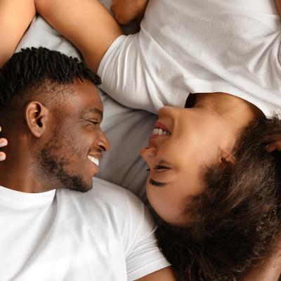 A black couple enjoying intimacy in bed.