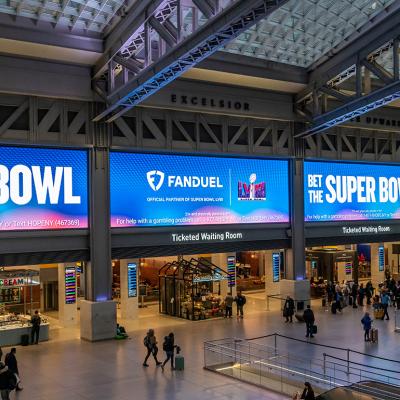 Ads for FanDuel, an online sports gambling copany, displayed on huge screens in the Moynihan Train Hall of Pennsylvania Station prior to the Super Bowl.