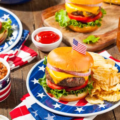 A set of homemade Fourth of July picnic meal such as burger, fries, and beans.