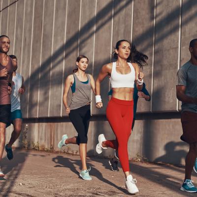 A group of people jogging outdoors.