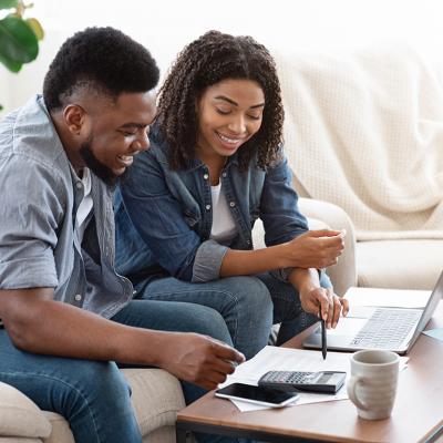 A black couple engaged in a discussion about finances.