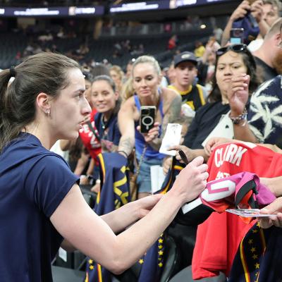 Caitlin Clark #22 of the Indiana Fever signs autographs for fans after warming up before a game against the Las Vegas Aces at T-Mobile Arena on June 22, 2025 in Las Vegas, Nevada.
