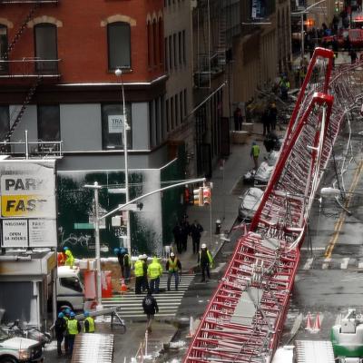 Emergency workers converge at the scene of a collapsed crane in a roadway in lower Manhattan on February 5, 2016 in New York City. 