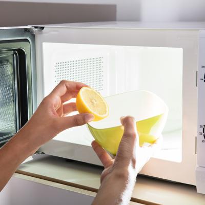 Microwave being cleaned with water and lemon.