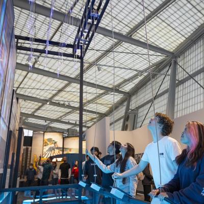 People interacting with a CityWorks exhibit exploring the water and wastewater infrastructure system.