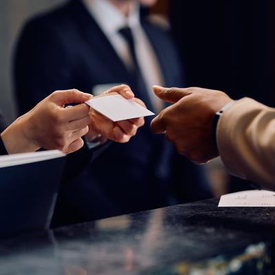 Hotel guest receiving a card key at the hotel reception.