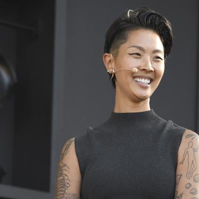 Chef Kristen Kish, wearing a black sleeveless mock turtleneck and mic headset speaks at a culinary demonstration during the 2025 Bottle Rock Napa Valley festival.