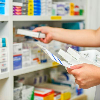 A pharmacist filling prescription at a pharmacy.