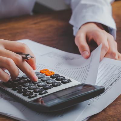 Business person calculating taxes.
