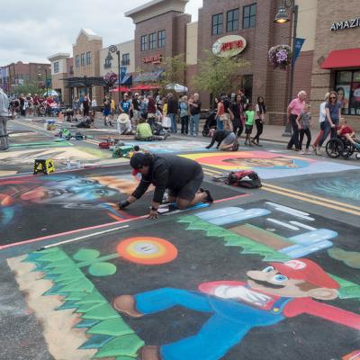 Chalk artists creating art during the Chalk Art Festival in Maple Grove, Minnesota.