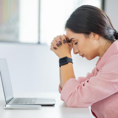 Young professional having a headache at work.